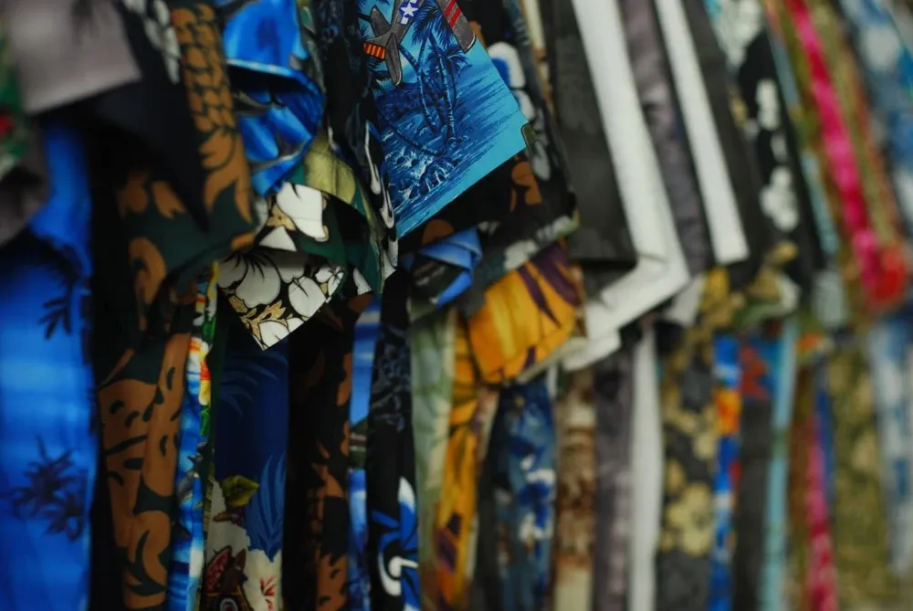 vintage aloha shirts hung inside a store
